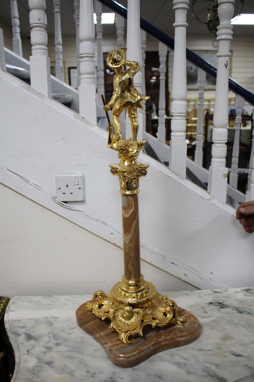 An ornate Italian gilt metal and marble centrepiece, modelled with a huntsman blowing his horn, height 72cm